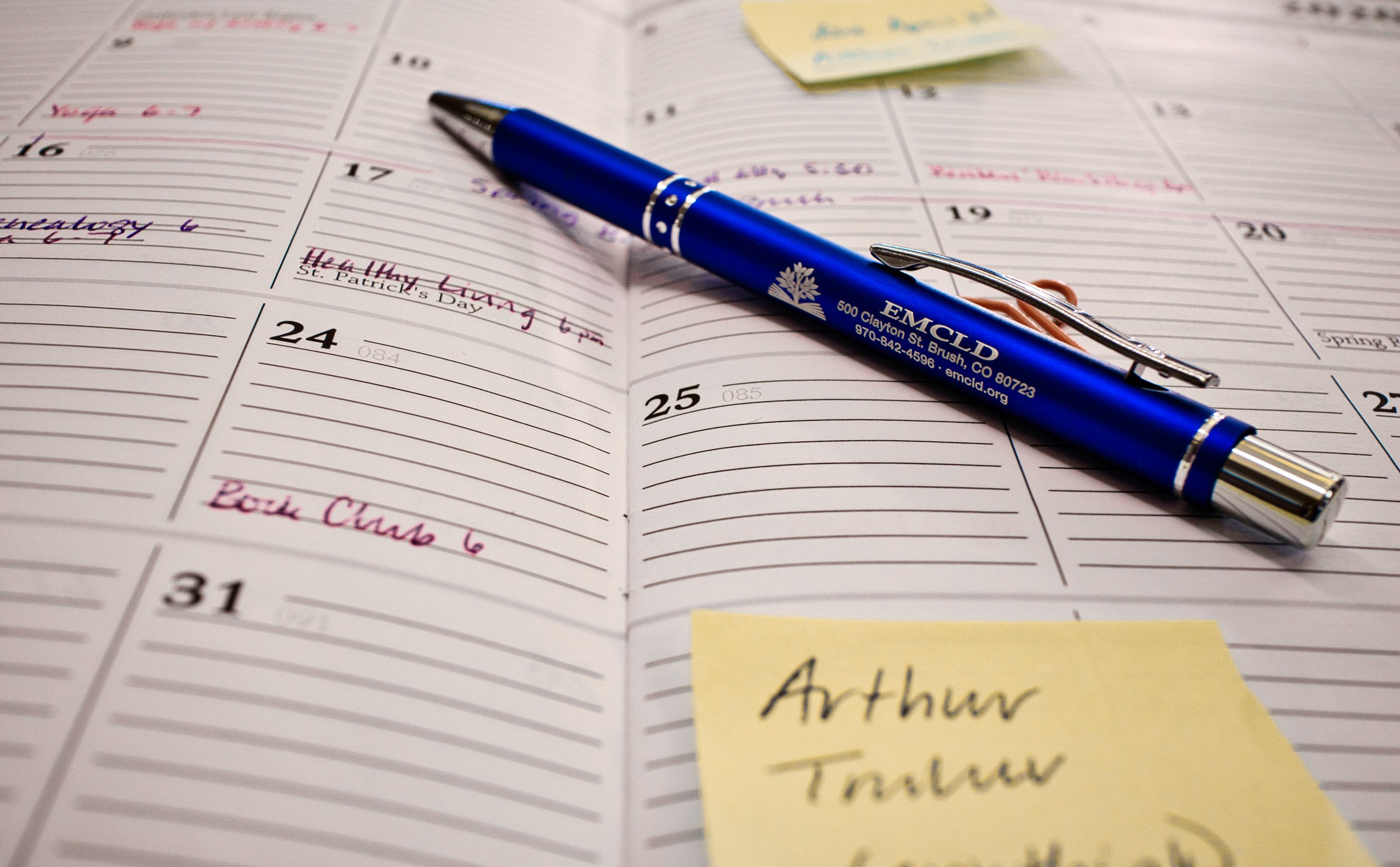 blue EMCLD pen on a calendar